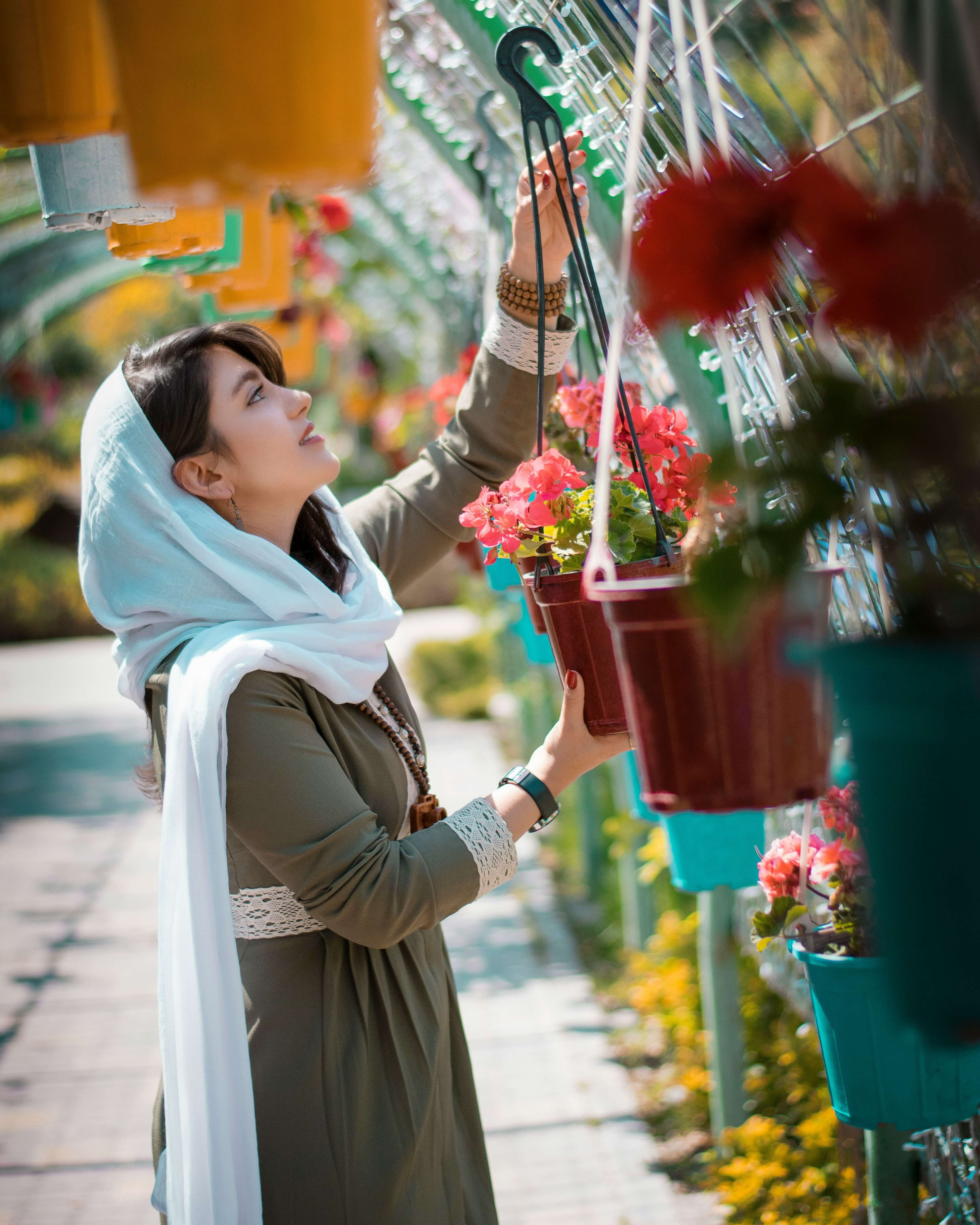 Woman hanging plants